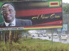 Traffic flows past a billboard with a portrait of  Emmerson Mnangagwa the new Zimbabwean President  in Harare, Zimbabwe, Monday, Nov.27, 2017. Zimbabwe's security forces said in a joint statement Monday that the "situation in our country had returned to normalcy", after a crisis during which the military staged a takeover and crowds demonstrated against Mugabe at the end of his 37 year rule.(AP Photo/Tsvangirayi Mukwazhi)