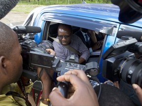 FILE - Zimbabwean Pastor Evans Mawarire talks to the press following his release from Chikurubi Maximum Prison on the outskirts of Harare, in this Thursday, Feb, 9, 2017 file photo. A Zimbabwean judge has acquitted Mawarire on Wednesday, Nov. 29, 2017 over charges that he tried to subvert the government of former President Robert Mugabe and invited people to come to commit violence during large anti government protests last year. (AP Photo/Tsvangirayi Mukwazhi, File)