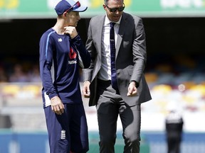 England's captain Joe Root, left, gets some advice from retired player Kevin Petersen during the Ashes cricket test between England and Australia in Brisbane, Australia, Friday, Nov. 24, 2017. (AP Photo/Tertius Pickard)