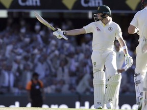 Australia's Steve Smith waves at the crowd after he reached 50 runs during the Ashes cricket test between England and Australia in Brisbane, Australia, Friday, Nov. 24, 2017. (AP Photo/Tertius Pickard)