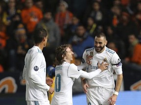 Real Madrid's Karim Benzema, right, celebrates after scoring the second goal of his team with Luka Modric, center, during the Champions League Group H soccer match between APOEL Nicosia and Real Madrid at GSP stadium, in Nicosia, on Tuesday, Nov. 21, 2017. (AP Photo/Petros Karadjias)