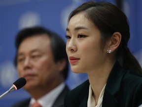 South Korea's 2010 Olympic gold medalist figure skater Yuna Kim, right, speaks during a press conference, Monday Nov. 13, 2017 at U.N. headquarters. The U.N. General Assembly adopted a South Korea sponsored resolution that 2018 Pyeong Chang Winter Olympics build a peaceful and better world through sport and Olympic ideal. (AP Photo/Bebeto Matthews)