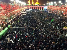 Shiite Muslim worshippers gather in front of the holy shrine of Imam Hussein, in the background, during the Muslim festival of Arbaeen in Karbala, 50 miles (80 kilometers) south of Baghdad, Iraq, Thursday, Nov. 9 , 2017. The holiday marks the end of the forty day mourning period after the anniversary of the 7th century martyrdom of Imam Hussein, the Prophet Muhammad's grandson. (AP Photo/Hadi Mizban)