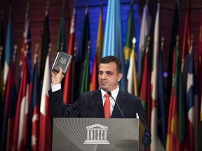 Israeli UNESCO ambassador Carmel Shama Hacohen displays a Bible as he addresses the 39th session of the General Conference at the United Nations Educational, Scientific and Cultural Organisation, UNESCO headquarters in Paris, Friday, Nov. 3, 2017. Hacohen, strongly criticized the organization Friday in Israel's last major speech before it formally withdraws from the U.N. cultural agency. He accused it of anti-Israel bias and called it "the Titanic of international organizations," and praised U.S. President Donald Trump's administration for deciding to quit UNESCO too. (AP Photo/Kamil Zihnioglu)