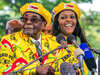 Zimbabwe’s President Robert Mugabe speaks at his party’s headquarters with his wife Grace on Nov. 8, 2017.