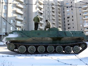 Ukrainian medical servicemen stand on an Armoured Personnel Carriers (APC) after they carried wounded servicemen to hospital in Ukraine controlling town of Avdiivka, in Donetsk region on January 30, 2017.