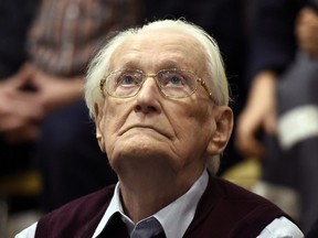 Ninety-six-year-old former SS sergeant Oskar Groening looks up as he listens to the verdict of his trial at a court in Lueneburg, northern Germany.
