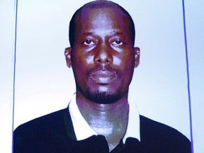 An image of Ali Omar Ader is projected on a screen at RCMP headquarters during a press conference about his arrest for the kidnapping of Canadian journalist Amanda Lindhout, in Ottawa on June 12, 2015. An emotional Amanda Lindhout recounted the horrors of being kidnapped at gunpoint in Somalia as the trial of one of her alleged hostage-takers got underway.