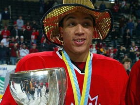 Anthony Stewart is shown with the world junior championship trophy.