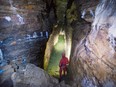 Cave explorer Daniel Caron looks at the walls of a cave located under a city park in Montreal.