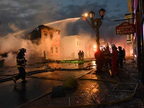 Firefighters from around the region work to control a multi-structure fire on Thursday, Nov. 30, 2017 in Cohoes, N.Y.