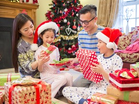 Family opening presents together on Christmas morning.