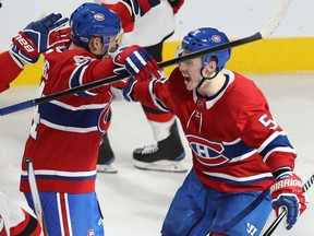 Charles Hudon,right, celebrates the goal by Canadiens teammate Tomas Plekanec during overtime in their game in Montreal on Thursday night against the New Jersey Devils.