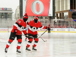 Ottawa Senators forwards Derick Brassard (left) and Ryan Dzingel practice outdoors at Lansdowne Park in Ottawa on Dec. 15.