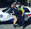 Yaya Torres poses with a Toronto police officer a the 2017 Pride parade.