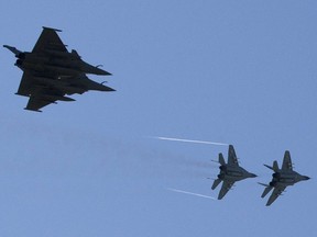 Two "Rafale" French fighter jets (L) and two polish Mig 29 fly over the air base in Malbork, Poland on April 29, 2014. JOEL SAGETJOEL SAGET/AFP/Getty Images