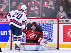 In this Jan. 5, 2017 file photo, U.S. forward Troy Terry scores on Carter Hart in the shootout of the world junior final.