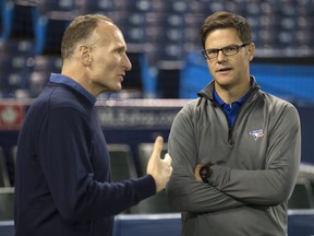 In this Oct. 18, 2016 file photo, Toronto Blue Jays general manager Ross Atkins (right) speaks with team president Mark Shapiro at the Rogers Centre.