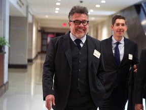 Russian-American lobbyist Rinat Akhmetshin (left) arrives at the Capitol for a closed door meeting with the House Intelligence Committee November 13, 2017 in Washington, DC. Akhmetshin was reported as one of the people participated in the June 2016 meeting between Russian lawyer Natalia Veselniskaya and Donald Trump Jr., and other Russian Trump campaign officials.