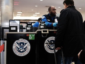 A Transportation Security Administration (TSA) worker screens passengers at LaGuardia Airport.