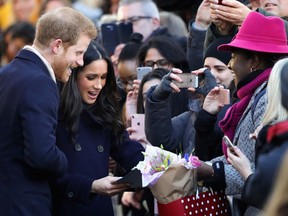 Prince Harry and Meghan Markle receive gifts from members of the public as they visit Nottingham Contemporary on December 1, 2017.