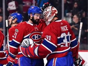 Montreal Canadiens goaltender Carey Price (right) celebrates a win over the Detroit Red Wings with defenceman David Schlemko on Dec. 2.
