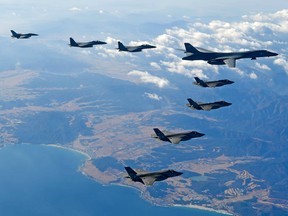 In this handout image provided by South Korean Defense Ministry, a U.S. Air Force B-1B bomber and South Korean and U.S. fighter jets fly over the Korean Peninsula during the Vigilant air combat exercise (ACE) on December 6, 2017.