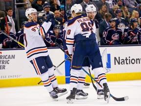 Connor McDavid, left, of the Edmonton Oilers congratulates teammate Jesse Puljujarvi (98) after scoring a goal during the third period against the Blue Jackets on Tuesday night at Nationwide Arena in Columbus, Ohio.