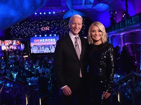 Hosts Anderson Cooper and Kelly Ripa pose onstage during CNN Heroes 2017 at the American Museum of Natural History on December 17, 2017 in New York City.
