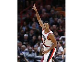 Portland Trail Blazers guard C.J. McCollum celebrates after hitting a three-point shot during the first half of an NBA basketball game against the Miami Heat, Wednesday, Dec. 13, 2017, in Miami.