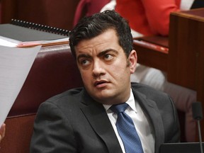 FILE - In this Dec. 4, 2017 file photo, Australia's Sen. Sam Dastyari attends question time in the Senate chamber at Parliament House in Canberra.  The influential Australian opposition lawmaker under fire over his close links to wealthy Chinese political donors announced on Tuesday, Dec. 12, 2017,  that he was quitting the Senate for the good of his party as the government moves against foreign interference in politics.