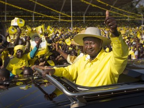 FILE - In this Tuesday, Feb. 16, 2016 file photo, Uganda's long-time President Yoweri Museveni waves to supporters from the sunroof of his vehicle as he arrives for an election rally at Kololo Airstrip in Kampala, Uganda. One of Africa's longest-serving leaders, Museveni could rule until 2031 after lawmakers late Wednesday, Dec. 20, 2017 passed contentious legislation that many in the East African nation saw as an attempt by the president to rule until the grave.