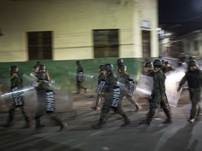 Military police patrols during government imposed dawn-to-dusk curfew in Tegucigalpa, Honduras, late Saturday, Dec. 2, 2017.  The main opposition candidate called Saturday for Honduras' disputed presidential election to be held again after the country erupted in deadly protests over the delayed vote count.