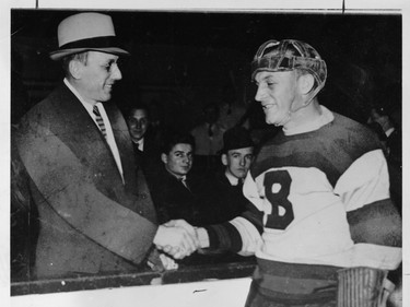 Ace Bailey (left) shakes hands with Bruins defenceman Eddie Shore at a benefit game for the injured Toronto Maple Leafs defenceman on Feb. 14, 1934.