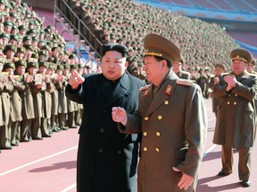 This undated file picture released from North Korea's official Korean Central News Agency (KCNA) on February 2, 2015 shows North Korean leader Kim Jong-Un (centre L) speaking with Hwang Pyong-So (centre R) as he meets with the participants in a meeting of military and political cadres at an undisclosed location in North Korea.
