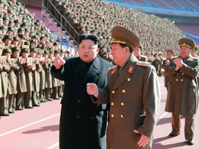 This undated file picture released from North Korea's official Korean Central News Agency (KCNA) on February 2, 2015 shows North Korean leader Kim Jong-Un (centre left) speaking with Hwang Pyong-So (centre R) as he meets with the participants in a meeting of military and political cadres at an undisclosed location in North Korea.