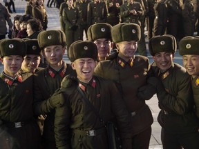 North Korean soldiers watch a fireworks display put on to celebrate the North's declaration on November 29 it had achieved full nuclear statehood.