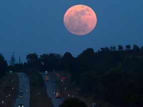 The supermoon rises over a highway near Yangon on December 3, 2017.