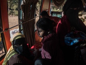 Rohingyas board a bus to take them to a refugee camp after arriving from Myanmar, near Shah Barir Dip at Cox's Bazar on December 3, 2017. Rohingya are still fleeing into Bangladesh even after an agreement was signed with Myanmar to repatriate hundreds of thousands of the Muslim minority displaced along the border, officials said on November 27.