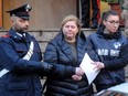 Maria Angela Di Trapani, a female mobster suspected of being the mastermind behind a reshuffle of the Sicilian Mafia following the death of  Toto Riina, is escorted by carabinieri during a police operation, on December 5, 2017 in Palermo.