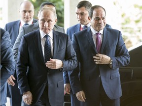 Egyptian president Abdel Fattah el-Sisi  welcomes his Russian counterpart  Vladimir Putin prior to their meeting in Cairo on December 11, 2017.