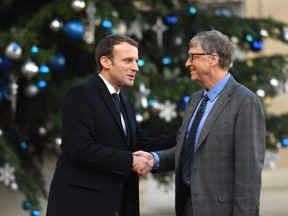 French President Emmanuel Macron greets U.S. entrepreneur and philanthropist Bill Gates as he arrives at the Elysee palace on December 12, 2017 in Paris, for a lunch hosted by the French President as part of the One Planet Summit. The French President hosts 50 world leaders for the "One Planet Summit", hoping to jump-start the transition to a greener economy two years after the historic Paris agreement to limit climate change.