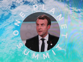 French President Emmanuel Macron is shown on a big screen as he delivers a speech at the One Planet Summit on December 12, 2017.
