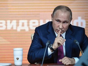 Russian President Vladimir Putin gestures as he speaks during his annual press conference in Moscow on December 14, 2017.
