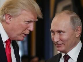 This file photo taken on November 11, 2017 shows Donald Trump  speaking with Russian President Vladimir Putin as they attend the APEC Economic Leaders' Meeting in Danang, Vitenam.