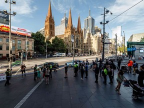 The street outside Flinders Street station is cordoned off by Australian police at the scene where a car ran over pedestrians in downtown Melbourne on December 21, 2017. The car ploughed into a crowd in Australia's second-largest city on December 21 in what police said was a "deliberate act" that left more than a dozen people injured, some of them seriously.
