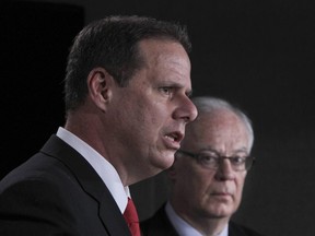 Yves Francoeur, president of Montreal's police brotherhood speaks as Robert Dutil, Quebec Minister of Public Safety looks on during a presser in Ottawa Wednesday Nov 17, 2011 concerning the Long-Gun Registry.