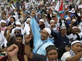 Protesters shout slogans during a rally against U.S. President Donald Trump's recognition of Jerusalem as Israel's capital at Monas, the national monument, in Jakarta, Indonesia, Sunday, Dec. 17, 2017.