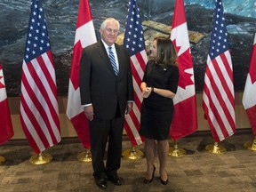 Foreign Affairs Minister Chrystia Freeland speaks with U.S. Secretary of State Rex Tillerson before a meeting in Ottawa, Tuesday December 19, 2017.