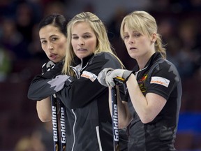 Team Jones skip Jennifer Jones, centre, stands with second Jill Officer and lead Dawn McEwen, right, during the Canadian Olympic curling trials against team Englot, in Ottawa on Sunday, December 3, 2017.